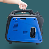 Blue portable generator with a hand on the handle against a dark green background