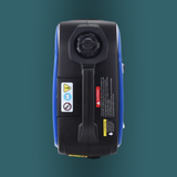 Top view of a blue and black device with warning labels on a teal background
