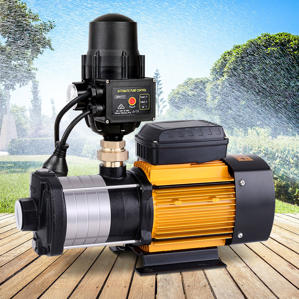 Pump outdoors on wooden decking, placed in front of a lush garden setting.