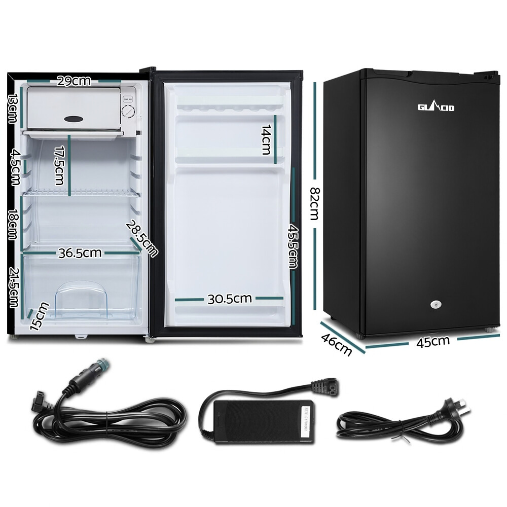 Small refrigerator with dimensions and power cord on a white background