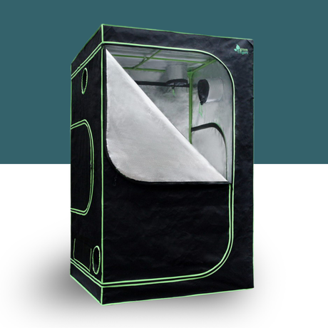 Glowing green grow tent with interior lights on a white background