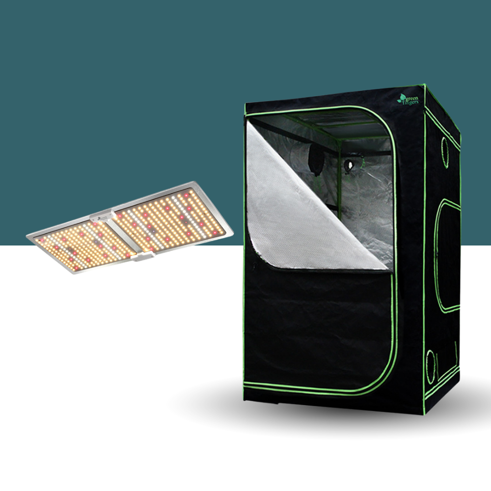 Black grow tent with LED light panel on a white surface against a teal background
