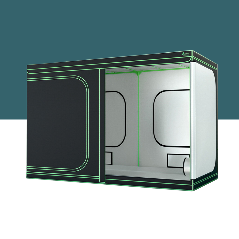 Large black indoor grow tent with green piping, open side panel showing white reflective interior and support frame.