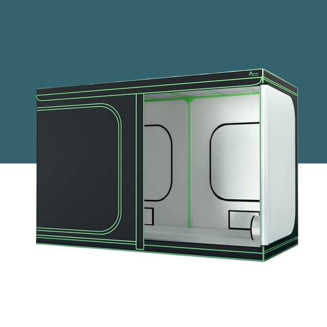 Large black indoor grow tent with green piping, open side panel showing white reflective interior and support frame.