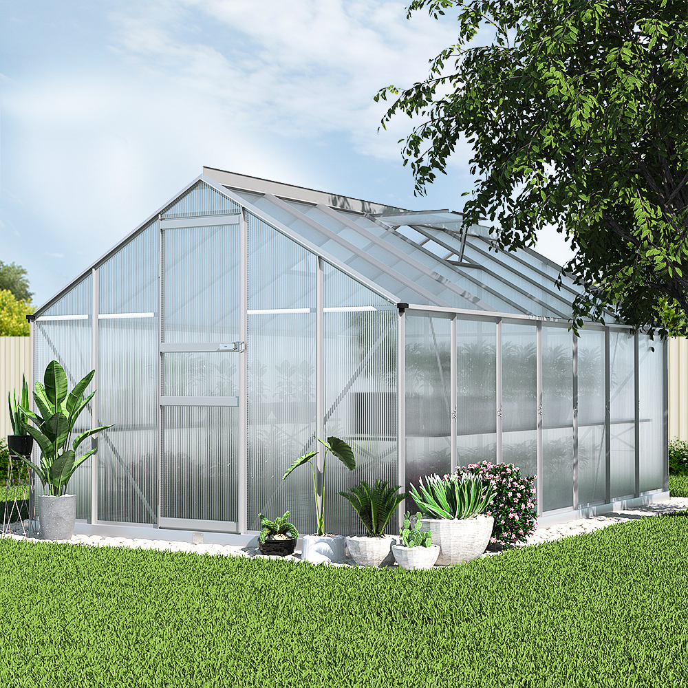 Greenhouse with plants in a garden setting