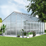 Greenhouse with plants in a garden setting
