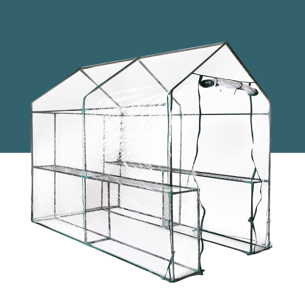 This image depicts the standalone greenhouse in detail, labelled as "greenfingers-1-2-x-1-9-x-1-9m-w4-shelf-walk-in-greenhouse". It is a spacious, walk-in structure with a transparent cover, a sturdy frame, and four shelves inside. The design allows for easy access and ample space for gardening, making it suitable for larger patios or backyard setups.