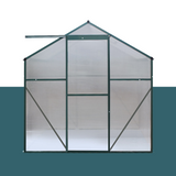 "Front view of a polycarbonate greenhouse with a sturdy aluminium frame, featuring large  door for easy access."