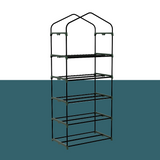 "Front view of a small, portable greenhouse with multiple wire shelves, ideal for compact spaces and plant protection."