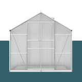 "Front view of a polycarbonate greenhouse with a sturdy aluminium frame, featuring large double doors for easy access."