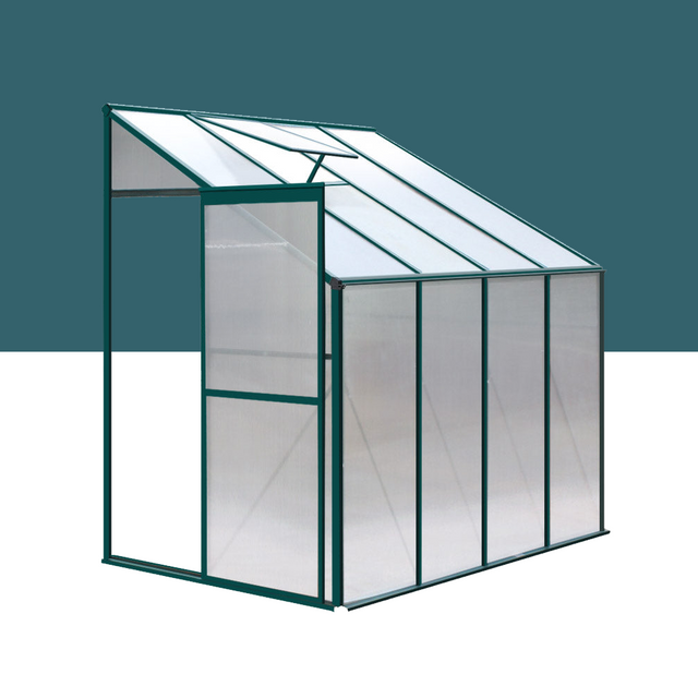 "Compact lean-to greenhouse with a sloped roof, featuring clear polycarbonate panels and a sturdy frame, ideal for small garden spaces."