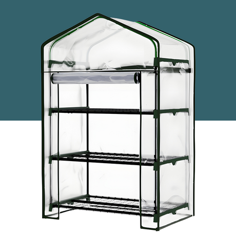 The 3-tier mini greenhouse with a transparent plastic cover, revealing three wire shelves inside, supported by a sturdy green frame. The greenhouse is designed for compact plant growing in small spaces.