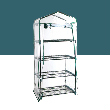 a standalone greenhouse structure with a transparent cover, featuring four tiers of shelving inside. It is labelled as "greenfingers-4-tier-1-6x0-7x0-5m-mini-greenhouse-garden-bed". The greenhouse has a sturdy metal frame and appears compact, suitable for small gardens or patios.