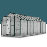 A sleek, modern aluminium polycarbonate walk-in greenhouse isolated against a solid blue background, showcasing its design.