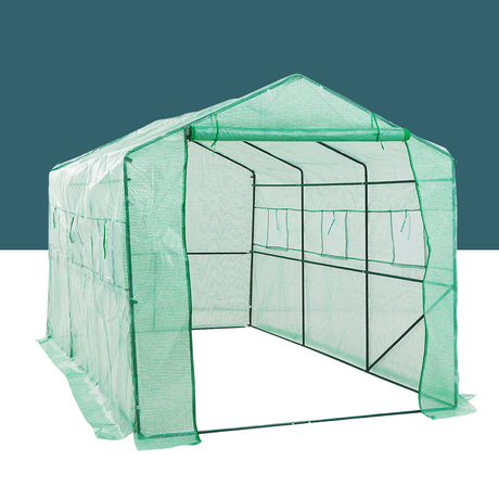 A green walk-in greenhouse with an open entrance, displaying its spacious interior framework. The greenhouse is covered with a UV-resistant mesh cover.