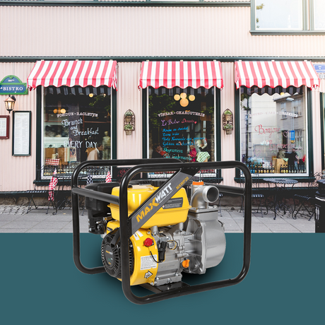 The MaxWatt 4-stroke petrol water pump is placed in front of a shop with striped awnings, illustrating its application in commercial or outdoor scenarios.