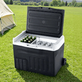 New Aim 30L 12V/24V/240V Portable Fridge Freezer with drinks on grass near a tent
