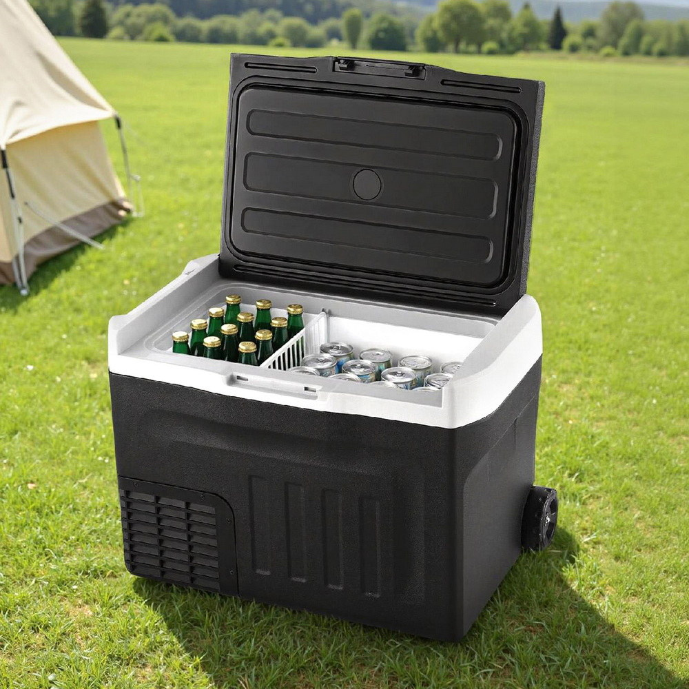 New Aim 30L 12V/24V/240V Portable Fridge Freezer with drinks on grass near a tent