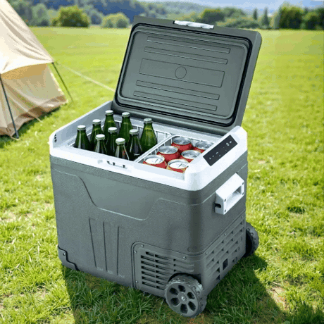 Portable cooler with drinks on a grassy field with a tent in the background