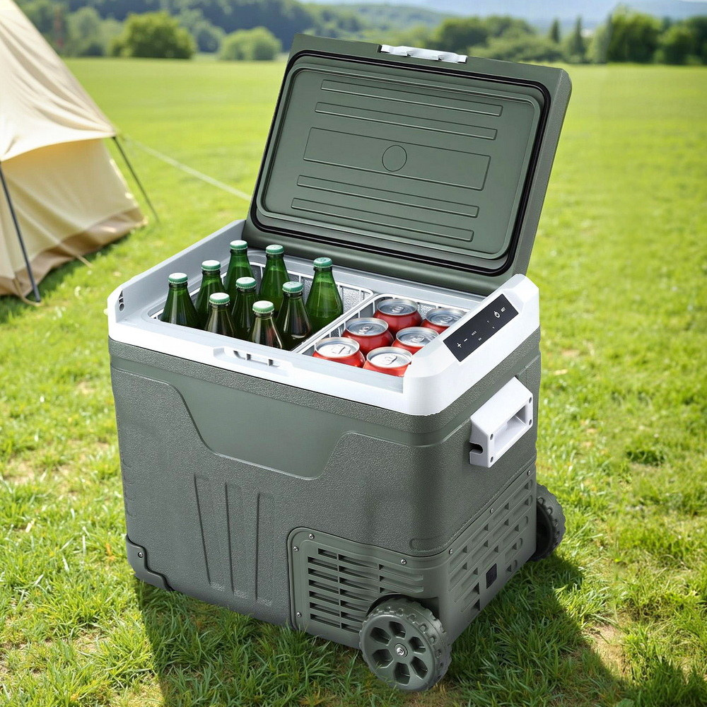 Portable cooler with drinks on a grassy field with a tent in the background