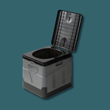 A high-angle shot of the assembled toilet against a dark teal background. The lid is open, showing the black seat and the grey boxy body.