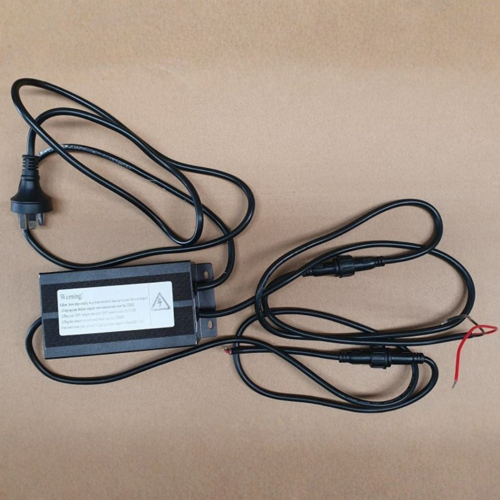 Electrical power adapter with cables on a brown background