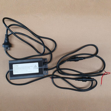 Electrical power adapter with cables on a brown background