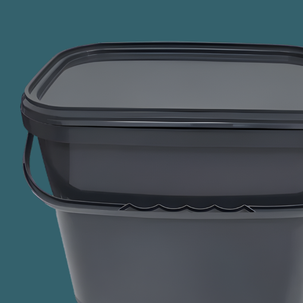 Trelino® Composting Toilet Solid Waste Container With Lid - Black on a teal background                         