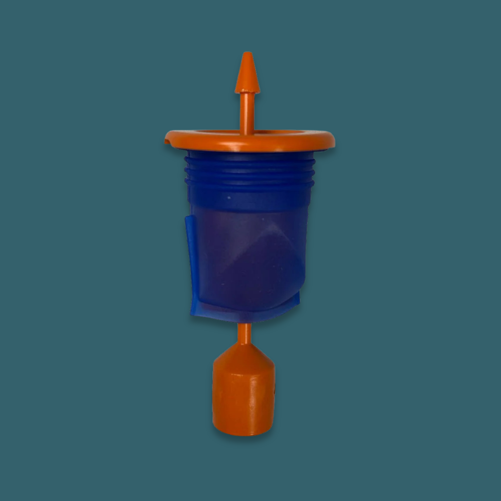 Blue and orange plastic component on a teal background
