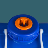 Close-up of a blue container with an orange valve on a green background