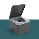 Gray portable toilet with open lid on a teal background