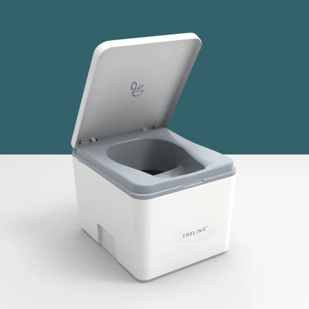 A white and gray portable toilet container with its lid open, shown on a clean white surface against a dark teal background. The brand name 'TRELINO' is visible on the front.
