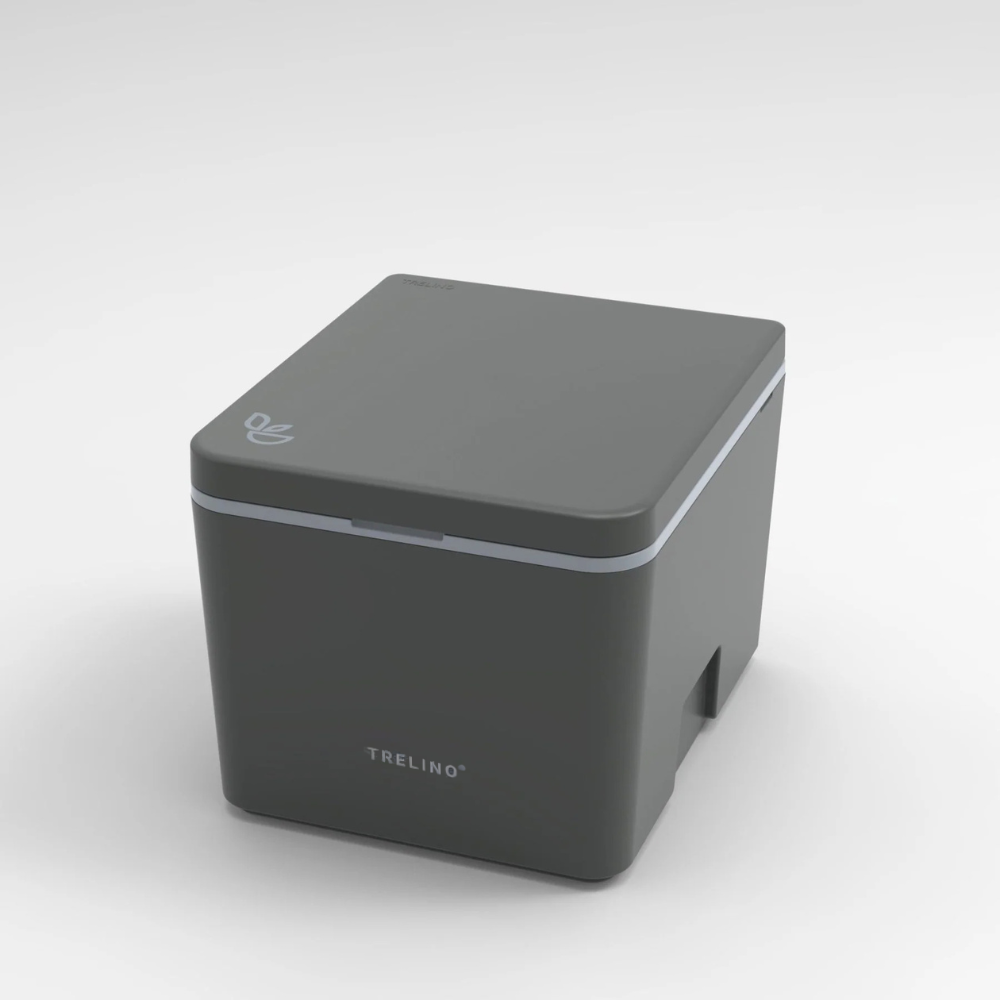 A dark gray TRELINOportable toilet shown at a three-quarter angle on a light gray gradient background.