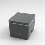 A dark gray TRELINOportable toilet shown at a three-quarter angle on a light gray gradient background.