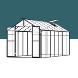 Glass greenhouse with black metal frame on a white background